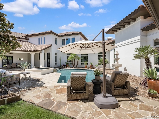 view of swimming pool with an in ground hot tub and a patio area