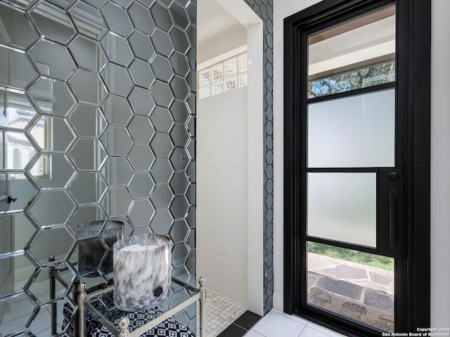 bathroom with a wealth of natural light and tile patterned floors