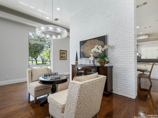 dining area with a notable chandelier and dark hardwood / wood-style floors