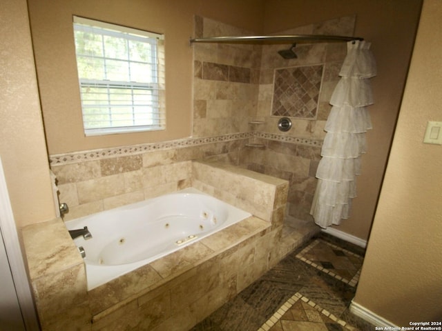 full bath featuring a tub with jets and tiled shower