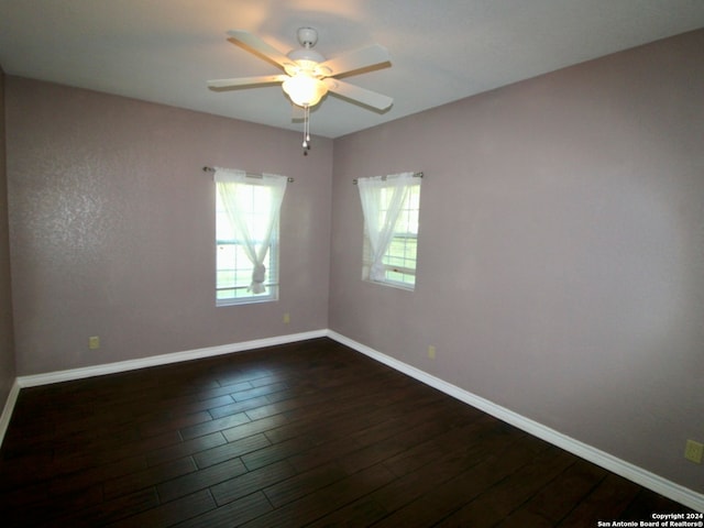 unfurnished room with dark hardwood / wood-style floors and ceiling fan