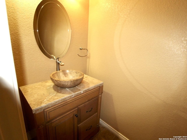 bathroom featuring baseboards and vanity