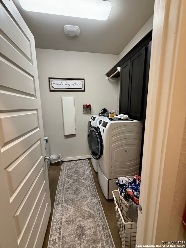 laundry area featuring cabinets and washing machine and dryer