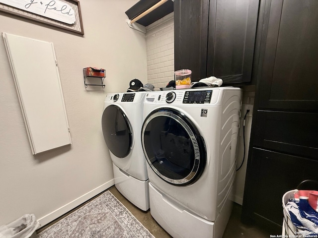 laundry area with cabinets and washing machine and clothes dryer