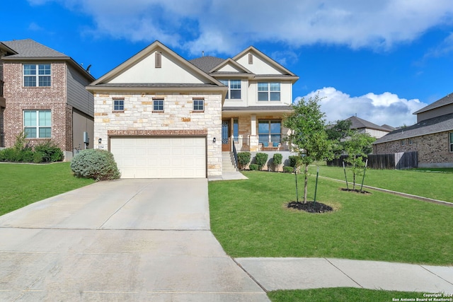 view of front facade featuring a porch, a front yard, and a garage