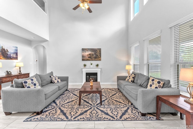 living room featuring a towering ceiling and ceiling fan