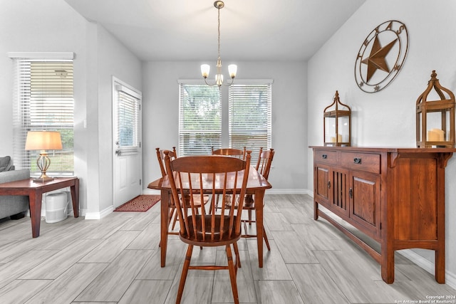 dining room with a chandelier and light hardwood / wood-style floors