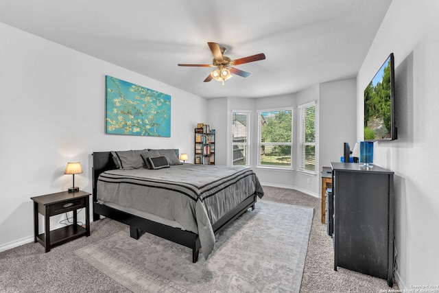 bedroom with ceiling fan and light carpet