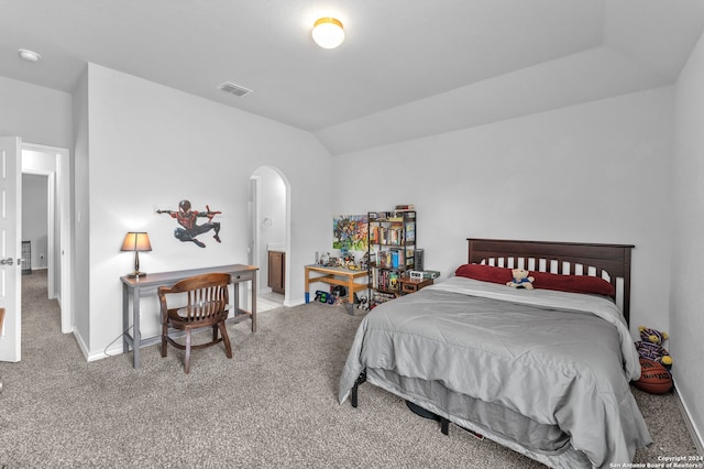 carpeted bedroom with vaulted ceiling