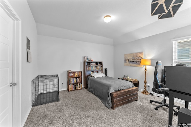 bedroom with carpet and lofted ceiling