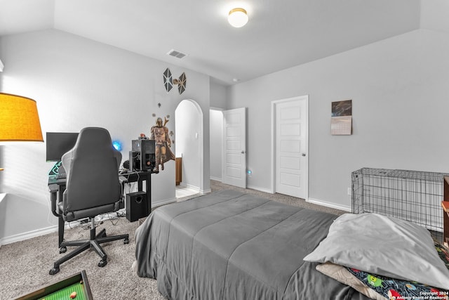 carpeted bedroom with vaulted ceiling