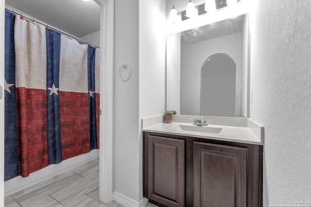 bathroom with a shower with curtain and vanity