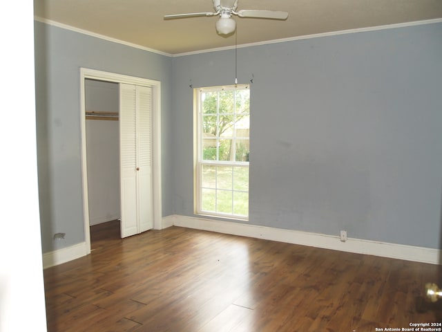 unfurnished bedroom featuring ornamental molding, dark hardwood / wood-style floors, ceiling fan, and a closet