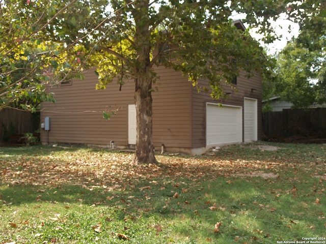 view of home's exterior with a lawn and a garage