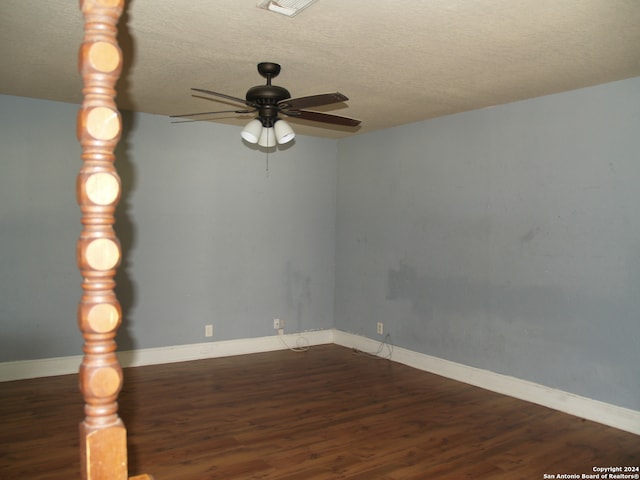 unfurnished room with a textured ceiling, dark hardwood / wood-style floors, and ceiling fan