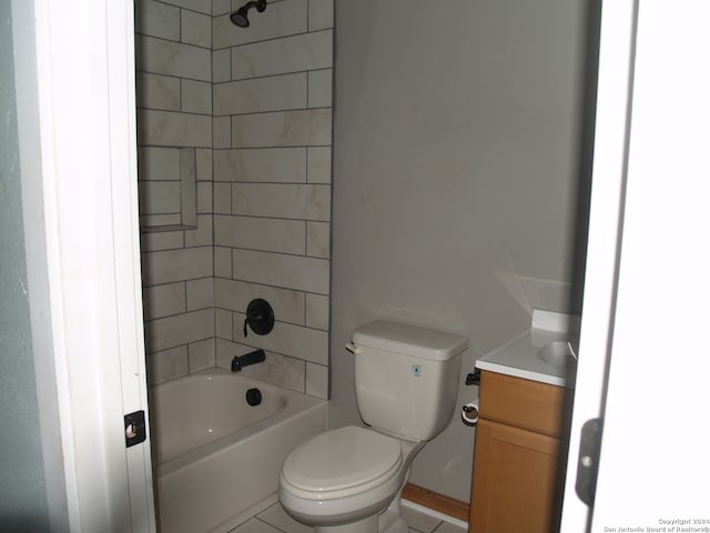 full bathroom with tiled shower / bath combo, vanity, toilet, and tile patterned floors