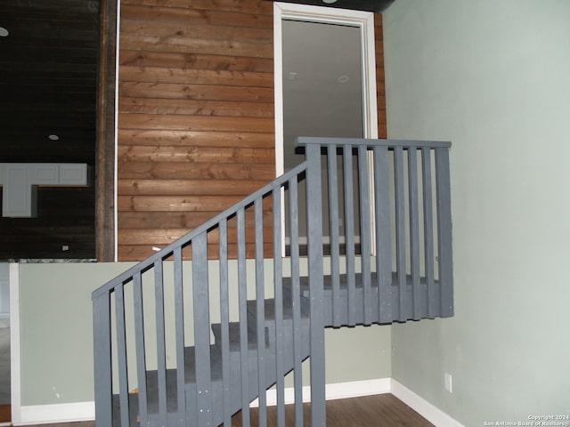 stairway featuring hardwood / wood-style floors and log walls