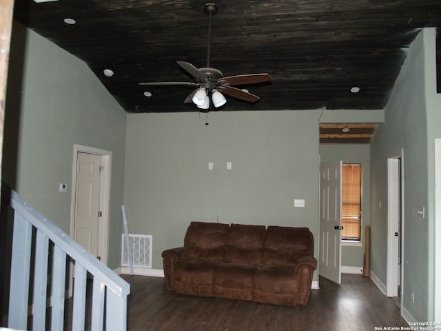 living room featuring ceiling fan, dark hardwood / wood-style floors, and vaulted ceiling