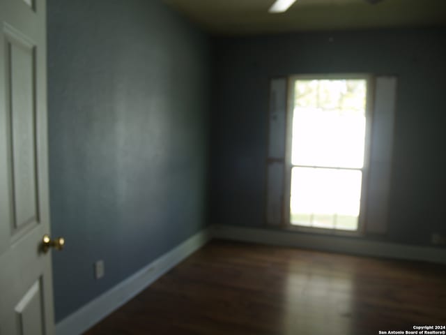 spare room featuring dark hardwood / wood-style flooring