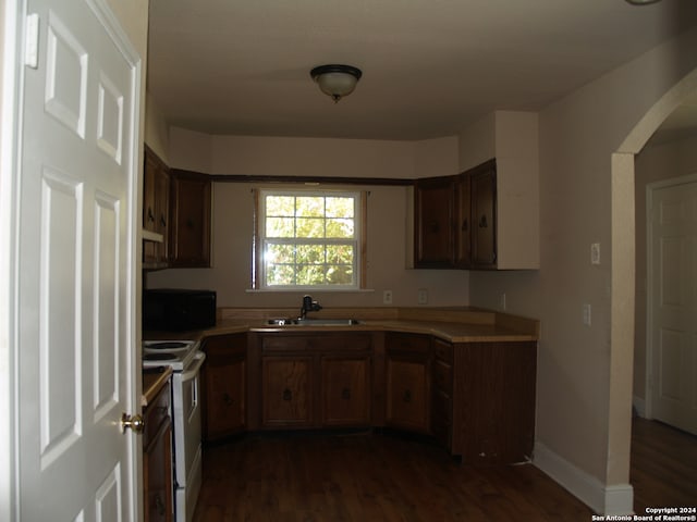 kitchen featuring white electric range oven, sink, and dark hardwood / wood-style flooring