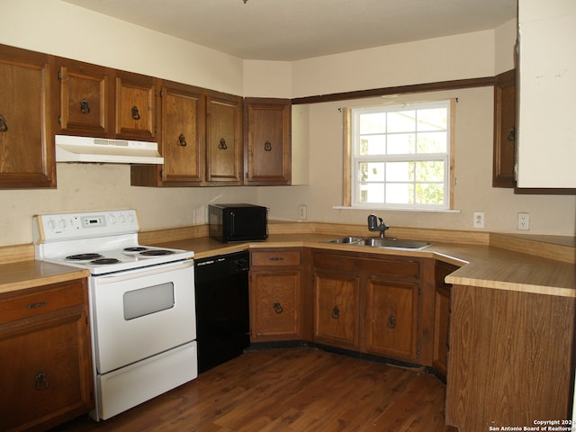 kitchen featuring dark hardwood / wood-style floors, sink, and black appliances