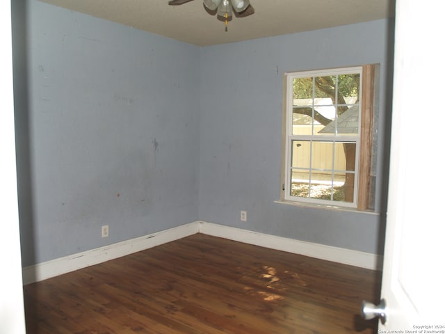 empty room featuring ceiling fan and dark hardwood / wood-style floors