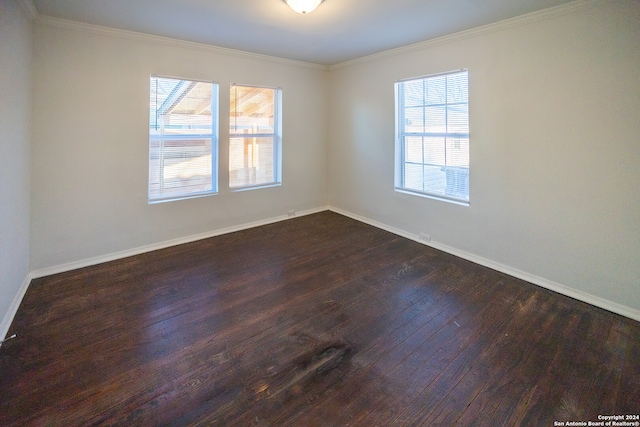 unfurnished room featuring crown molding, dark hardwood / wood-style flooring, and a wealth of natural light