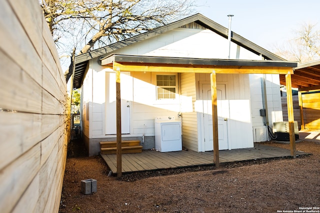 rear view of property with a deck and washer / dryer