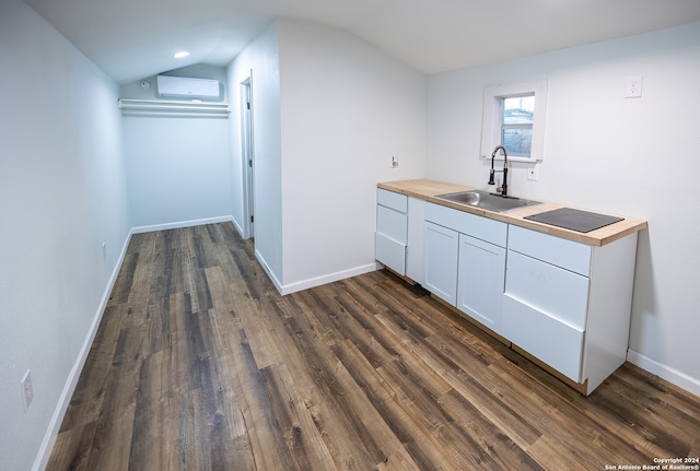 kitchen with white cabinetry, dark hardwood / wood-style flooring, wooden counters, lofted ceiling, and sink