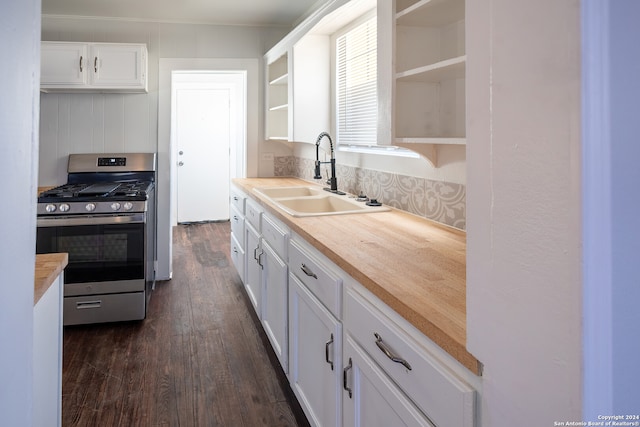 kitchen with stainless steel gas range oven, dark hardwood / wood-style floors, sink, and white cabinetry