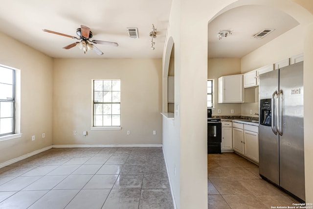 kitchen featuring ceiling fan, white cabinets, stainless steel fridge with ice dispenser, and a healthy amount of sunlight