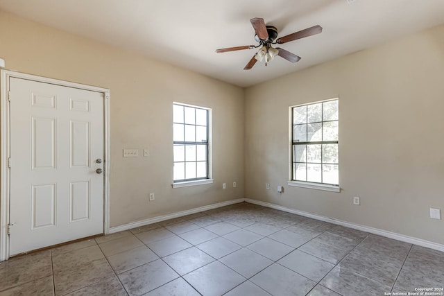 unfurnished room with ceiling fan, plenty of natural light, and light tile patterned flooring