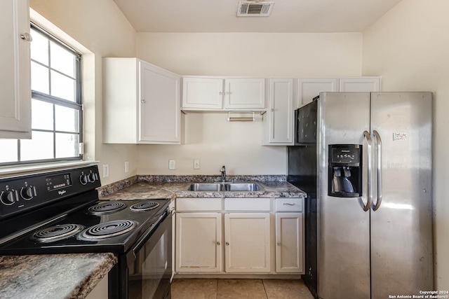 kitchen with white cabinets, light tile patterned floors, black electric range, stainless steel refrigerator with ice dispenser, and sink