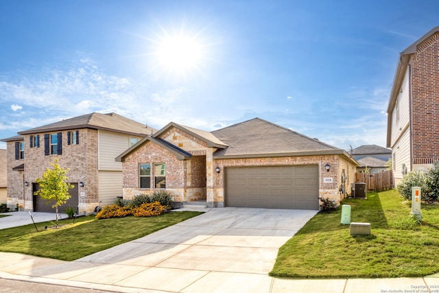 view of front of property featuring a garage, central AC, and a front yard