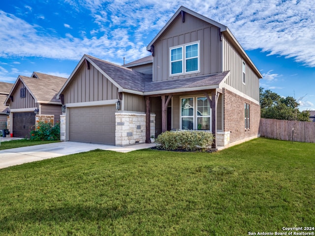 view of front of property featuring a garage and a front lawn