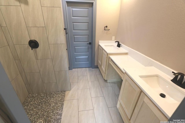 bathroom with vanity and tiled shower