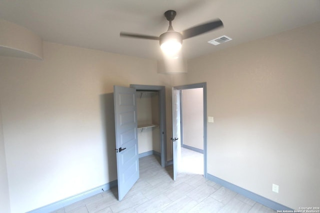 unfurnished bedroom with a closet and ceiling fan