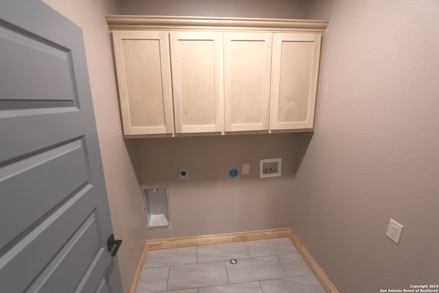 clothes washing area featuring washer hookup, cabinets, light tile patterned floors, and electric dryer hookup