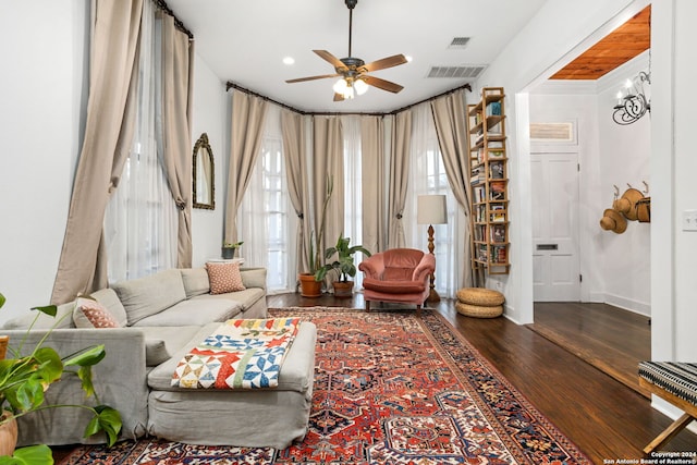 living room featuring dark hardwood / wood-style flooring and ceiling fan