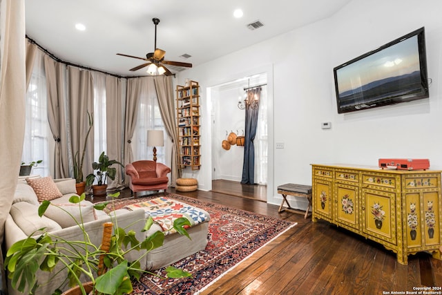 living room featuring ceiling fan and dark hardwood / wood-style flooring