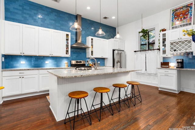 kitchen featuring stainless steel appliances, white cabinetry, and dark hardwood / wood-style flooring