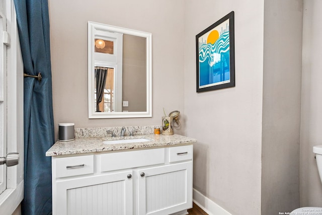 bathroom featuring vanity and toilet