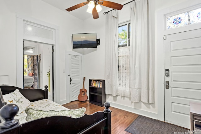 living room with ceiling fan and dark wood-type flooring