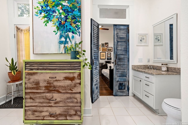 bathroom featuring tile patterned flooring, vanity, and toilet