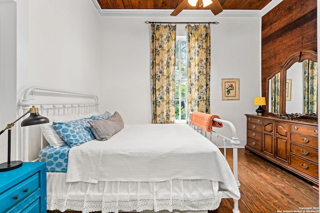 bedroom featuring ceiling fan, beam ceiling, wooden walls, dark hardwood / wood-style floors, and crown molding