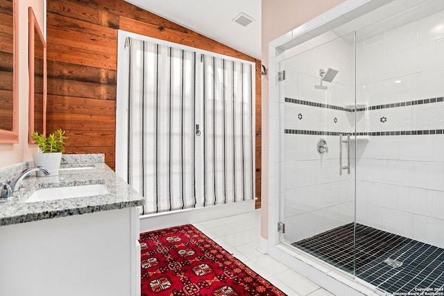 bathroom featuring vaulted ceiling, wood walls, and a shower with door