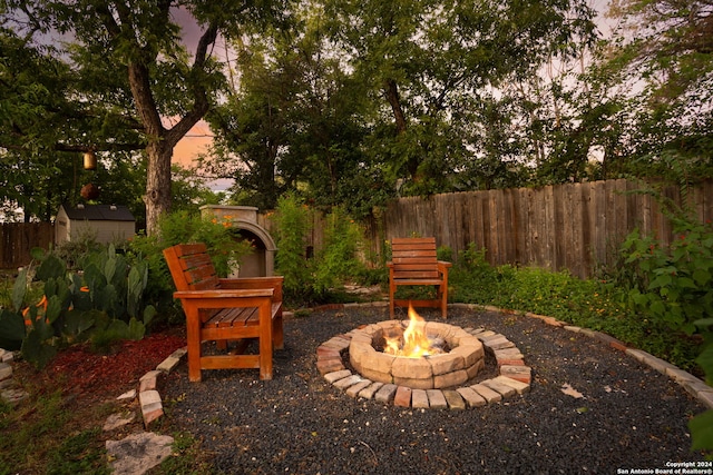 yard at dusk with a fire pit