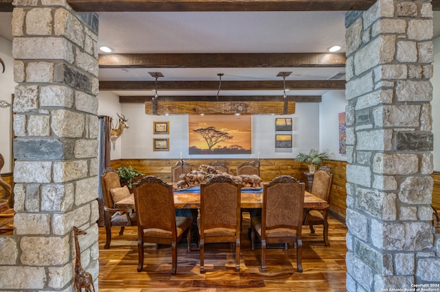 dining area featuring wood-type flooring and beam ceiling