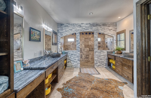 bathroom featuring tile walls, vanity, and tiled shower