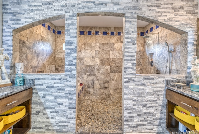 bathroom with vanity and tiled shower